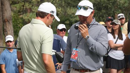 Matt Fitzpatrick chats with a Rules official