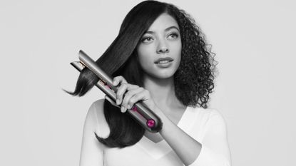 Dyson model with natural textured hair straightening her hair with the Dyson Corrale - dyson corrale black Friday 