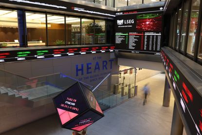 Stock price information displayed in the London Stock Exchange Group Plc&#039;s office atrium in the City of London, UK