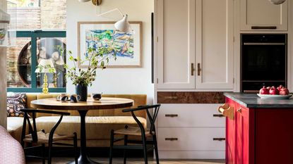 White kitchen with red island decorated for hosting