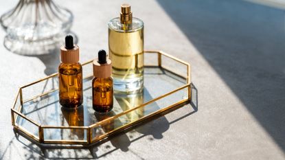 beauty products on a glass tray