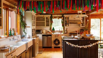 an eclectic cottage kitchen decorated for christmas with paper garlands and felt wreaths