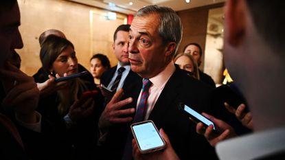 Nigel Farage surrounded by journalists