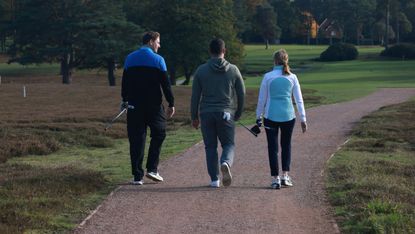 Three golfers walking