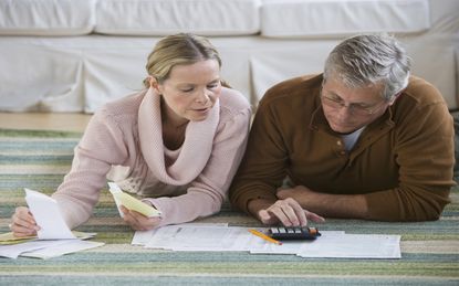 Senior couple going over paperwork for retirement