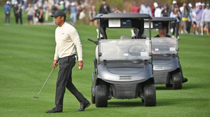 Tiger Woods walking next to a golf cart at the 2022 PNC Championship