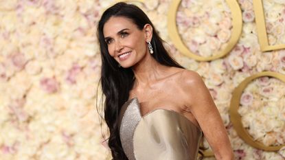 demi moore wearing a gold dress during golden globes 2025