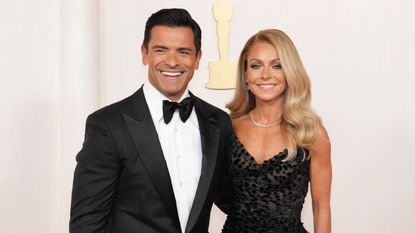 kelly ripa and mark consuelos on a white background