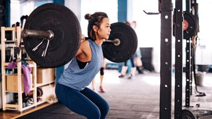 Photo of someone weight lifting in a gym