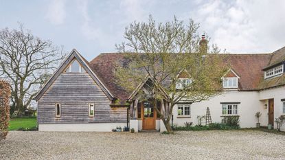 17th Century Period Cottage with wood clad oak frame extension and gravel driveway