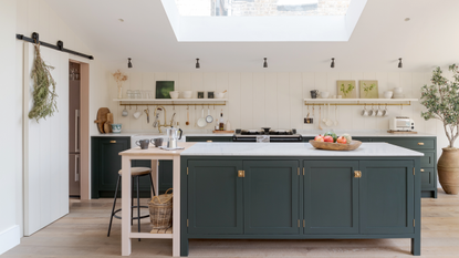 green country-style kitchen with island and butcher&#039;s table