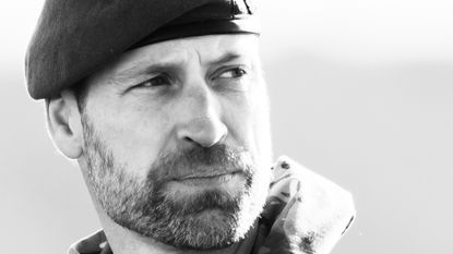 A black and white photo of Prince William wearing a beret and looking to the right with a serious expression