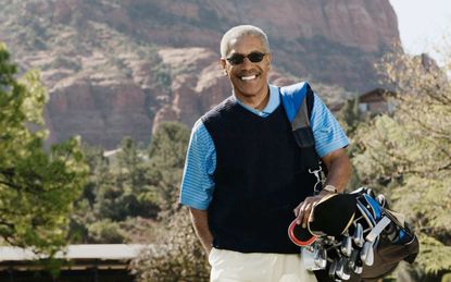 Senior man playing golf poses for a photo in Arizona