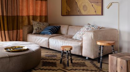 a beige couch with different colored throw pillows