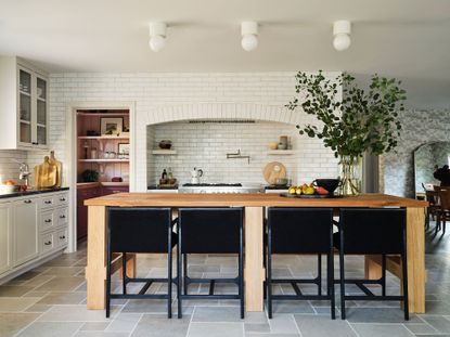 a white kitchen with a colorful pantry