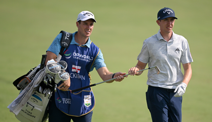 Tom McKibbin and his caddie walk down the fairway