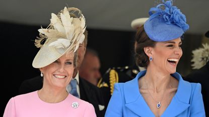 Duchess Sophie wears a bright pink dress and matching hat and Kate Middleton wear a blue jacket with matching hat