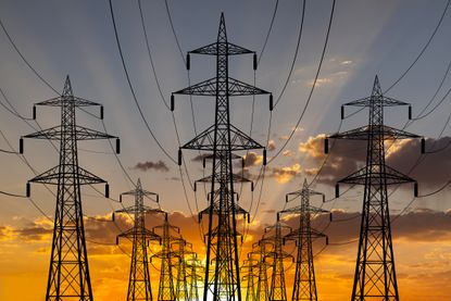 High voltage power line towers at sunset