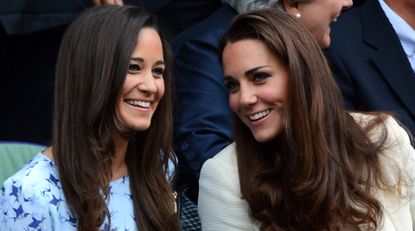 Pippa and Kate Middleton smile and both have long brown hair as they attend Wimbledon in 2012