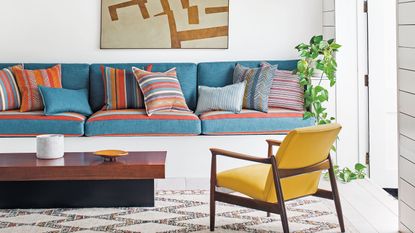 White living room with blue sofa cushions