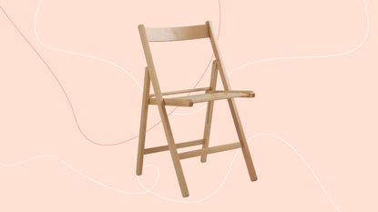 habitat light wood folding chair on a pink background