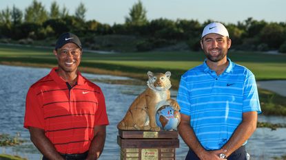 Tiger Woods and Scottie Scheffler stand next to the Hero World Challenge trophy in 2023