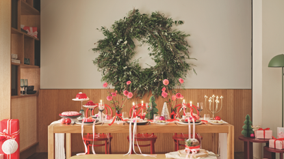 Giant foliage wreath in front of pink tablescape