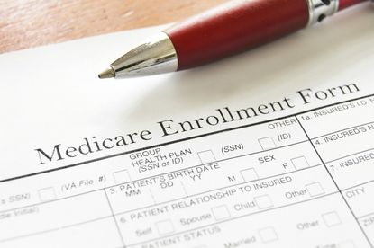 Closeup of Medicare open enrollment form and pen.