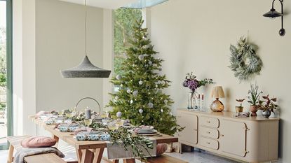 Christmas tree in corner of a room with neutral decorations