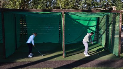 Golfers hitting into nets