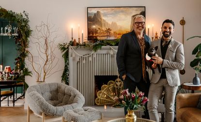 interior designer alykhan velji in front of his christmas fireplace