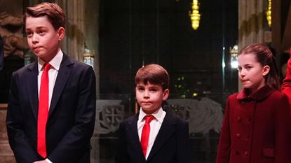 Prince George and Prince Louis wear matching suits with white shirt and red ties, while Princess Charlotte wears a red coat to attend Kate Middleton&#039;s Christmas carol concert