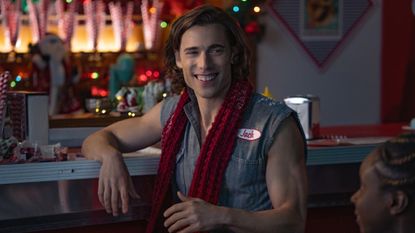 Dustin Milligan as Jack, sitting at a diner counter, in &#039;Hot Frosty.&#039;