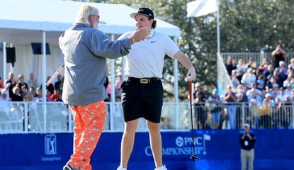 John Daly and John Daly II hug on the 18th green