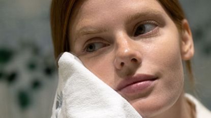 Woman using a wash cloth to rinse her skin