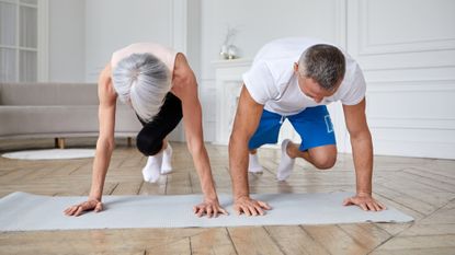 Man and woman exercising in domestic setting