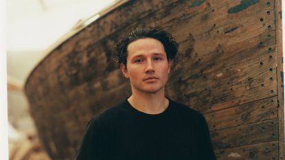 Emerging designer Marc Sweeney, photographed by Norman Wilcox-Geissen, in his father’s boatyardin Loch Lomond, with his ‘Pylon’ spun aluminium candleholders @marc__sweeney