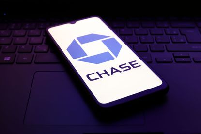 Chase logo on smartphone sitting on laptop keyboard 