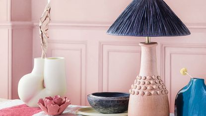 Pink wall with table lamp with blue shade