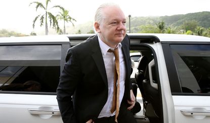 Julian Assange arrives in court in Saipan