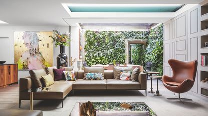 Living room in extended home, with roof windows and large opening to the garden with Mid-Century Modern furniture