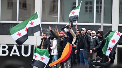 Syrian refugees in Germany, waving Syrian flags