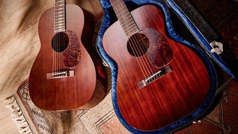 Atkins Dust Bowl 00014 and 0012S acoustic guitars on a rug and wooden floor