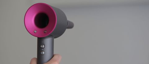 The Dyson Supersonic hair dryer being held upright