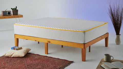 The Eve Premium Hybrid Mattress photographed on a wooden bed frame as part of the review process