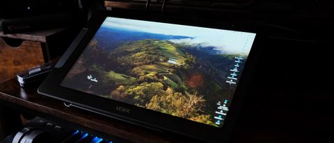 the Veikk studio 16 pen display on a desk, with accessories.