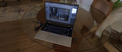 A Framework Laptop 16 on a glass table