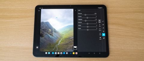 OnePlus Pad Go showing the Lightroom app on a wooden table