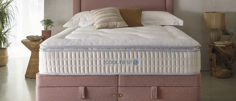 The Sleepeezee Cool Rest 1800 Mattress on a bed frame in a bedroom