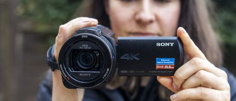 A female photographer holding the Sony AX43 camcorder